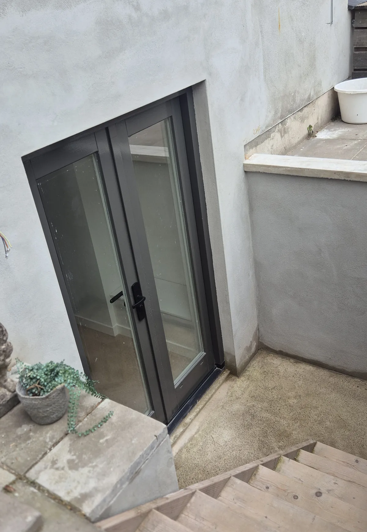 A few steps down to the French doors of the private entrance