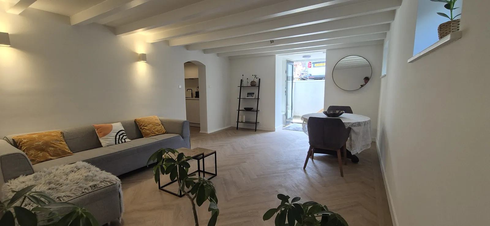 Living room with beamed ceiling and herringbone floor